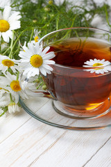 Chamomile tea on wooden table still life