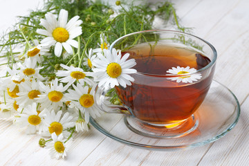 Chamomile tea on wooden table still life