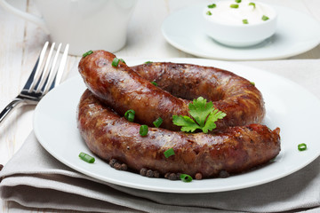 Traditional homemade coiled sausage on wooden table