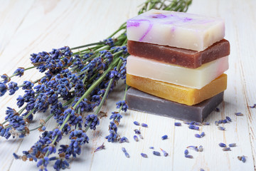 Natural handmade soap stack with lavender on wooden table