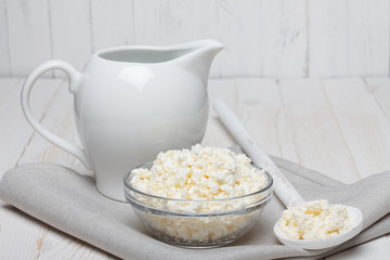 Cottage cheese on white wooden table