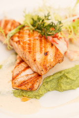 Grilled salmon steak with salad