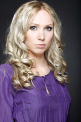 Fototapeta premium Beautiful young woman on dark background