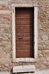 Brown wooden door in old house Italy