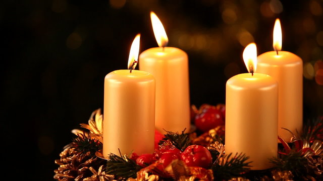 Candles on advent wreath and black copy space.