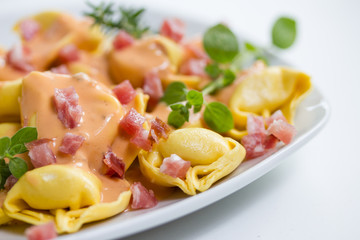 fresh tortellini in light sauce with ham