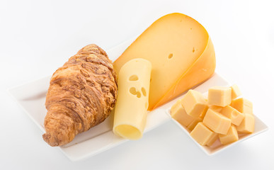 Various types of cheese and croissant  isolated on white