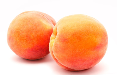 Two ripe peaches isolated on a white