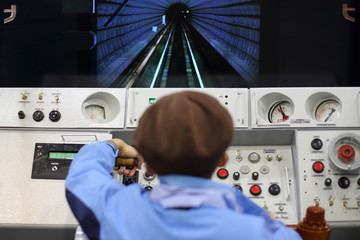Man on simulator control panel subway car