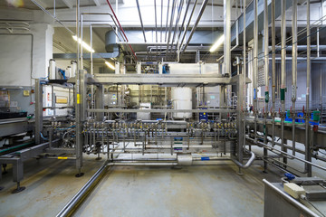 Lots of pipes and tanks in the shop of brewery