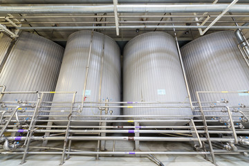 Large shiny tanks and tubing in the brewery