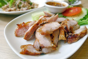 Slice grilled pork on white plate