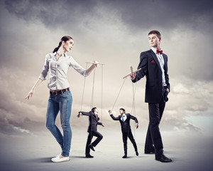 Businesspeople with marionettes