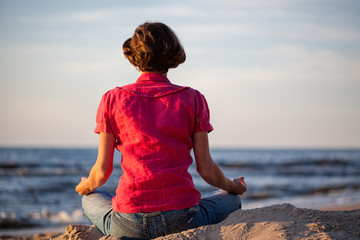 Woman meditating at seaside
