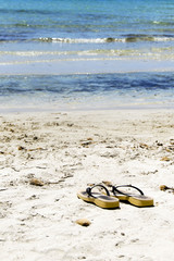 Fototapeta na wymiar Flip flops on the beach