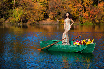 Fototapeta na wymiar woman on a boat in the autumn