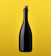 bottle of sparkling wine with cork on a colored background yello