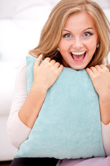 smiling woman hugging pillow