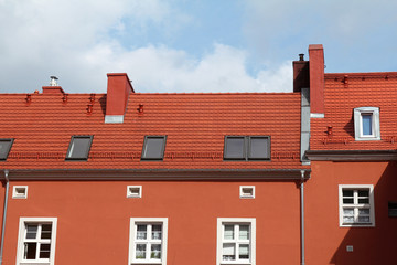 red building with tile roof against blue sky