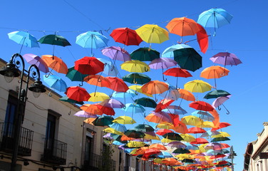 Fototapeta na wymiar Street decorated with colored umbrellas, Madrid, Getafe, Spain