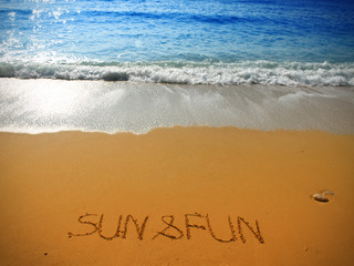 beautiful coastline landscape and handwritten text on the sand