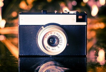 Old camera on gold background