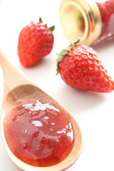 Homemade jam with strawberry on background