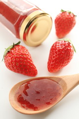 Homemade jam with strawberry on background