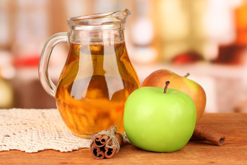 Full jug of apple juice and apple