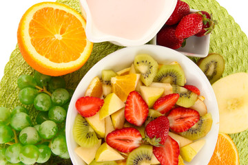 Useful fruit salad of fresh fruits and berries in bowl