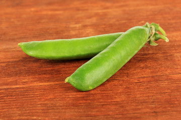 Sweet green peas on wooden background