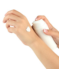 Woman applying cream on hands, isolated  on white