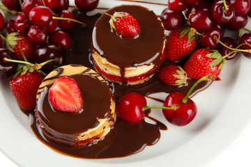 Tasty biscuit cakes with chocolate and berries