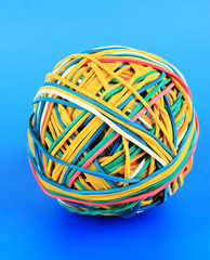 Colorful rubber bands on blue background