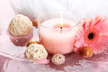 Fototapeta na wymiar Beautiful pink candle with flower in water