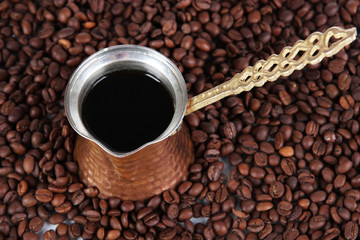 Coffee pot on coffee beans background
