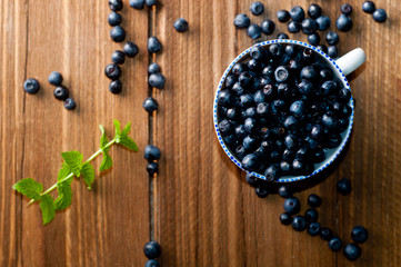 bowl of blueberries on a wooden background