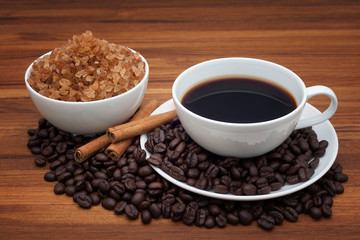 Coffee cup and beans on wood table
