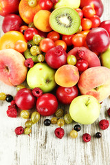 Assortment of juicy fruits, on wooden background