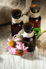 Medicine bottles with purple echinacea flowers