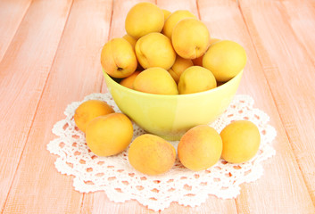 Fresh natural apricot in bowl on wooden table