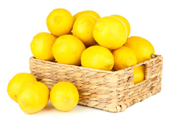 Ripe lemons in wicker basket isolated on white