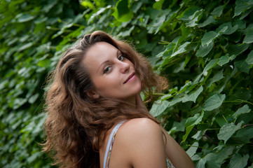 Fototapeta premium fashion model on a background of foliage