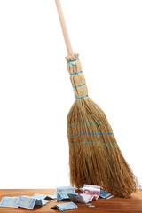 Broom sweep the euro on white background close-up