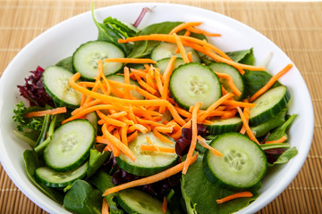 White Bowl of Salad with Cucumbers and Carrots