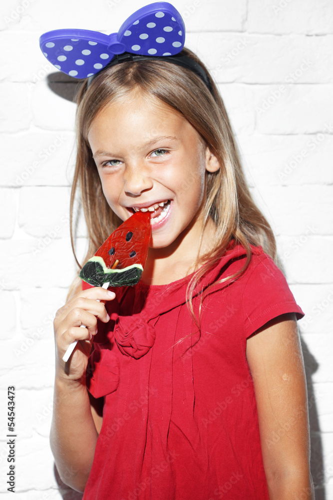 Wall mural child eating lollipop