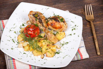 Grilled chicken legs with potato and vegetables