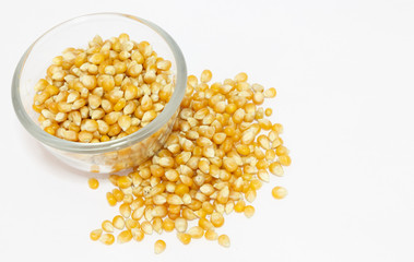 yellow corn grain in bowl isolated on white background