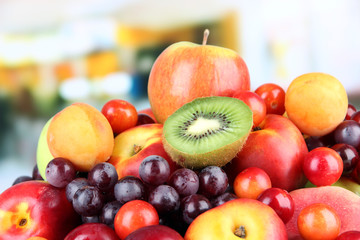 Assortment of juicy fruits on bright background