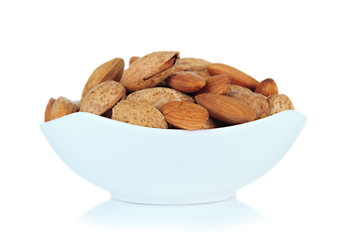 Almond in bowl, isolated on white